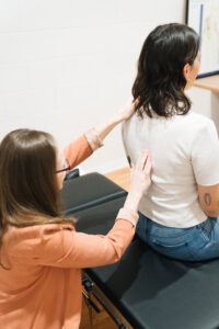 Dr Kimberley checking client's spine