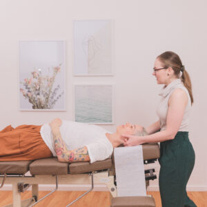 Nest Birth & Wellbeing Chiropractor and patient client laying supine on table