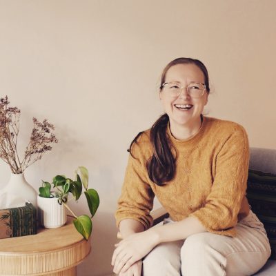 Dr Kimberley Garrard sitting and smiling laughing